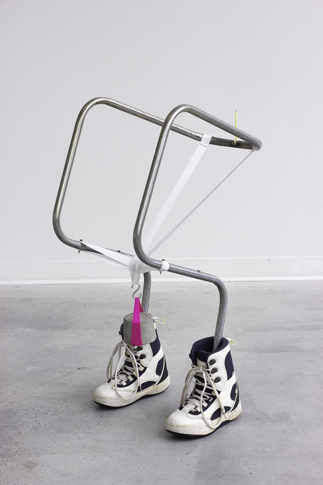 <i>Boots</i> <br> Steel, ski boots, candle, elastic, concrete, sand, 33.5 x 14 x 20 in, 2021.