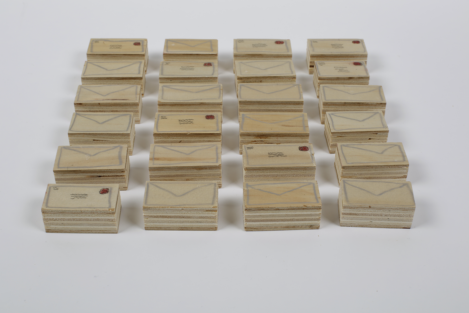 <i>Envelopes</i> <br> Drawing on wood, 1.5”x3/4’, 2021 